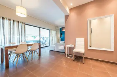 a dining room with a table and chairs at Glyfada Glass-Walled Designed Apt 1Gbps in Athens