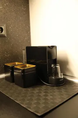 a black coffee maker on a counter in a room at Super Stylish Apartments in the Heart of Athens! in Athens