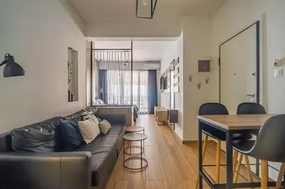 a living room with a couch and a table at Super Stylish Apartments in the Heart of Athens! in Athens