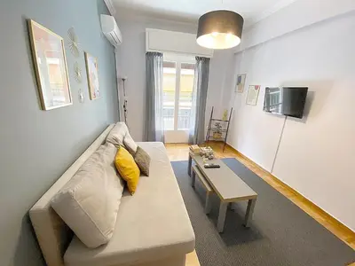 a living room with a couch and a table at Check Point - Veikou in Athens