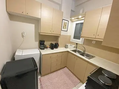 a small kitchen with a sink and a washing machine at Check Point - Veikou in Athens