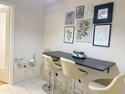 a dining room with a black table and chairs at Check Point - Veikou in Athens