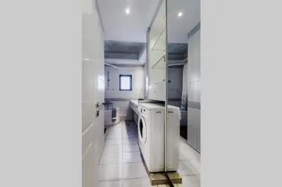 a white laundry room with a washer and dryer at Spacious apartment in Glyfada close to the sea in Athens