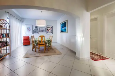 a dining room with a table and chairs at Spacious apartment in Glyfada close to the sea in Athens