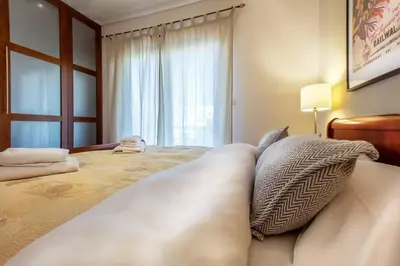 a bedroom with a large bed with pillows on it at Spacious apartment in Glyfada close to the sea in Athens