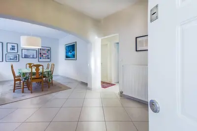 a kitchen and dining room with a table and chairs at Spacious apartment in Glyfada close to the sea in Athens