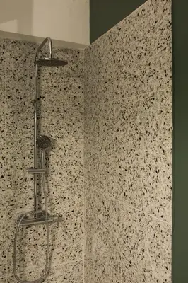 a shower in a bathroom with a tile wall at Mosaics aprtm in Parliament square with Acropolis View 14 in Athens