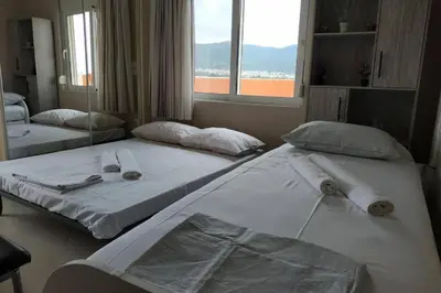 two twin beds in a room with a window at Psychiko's View in Athens