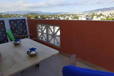a table and chairs on a balcony with a view at Psychiko's View in Athens