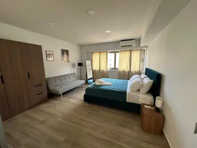 a bedroom with a bed and a couch at Academys Modern Apartments by Athens Urban Retreat in Athens
