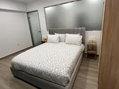 a bedroom with a large bed with white pillows at Academys Modern Apartments by Athens Urban Retreat in Athens