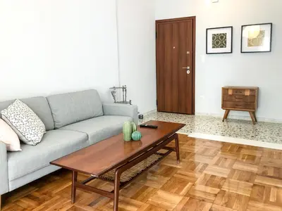 a living room with a couch and a coffee table at Athens Sea view 2 floor apartment next to Marina in Athens