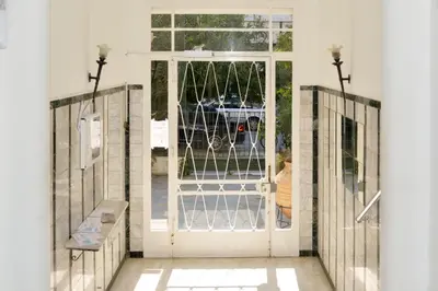an entrance to a house with a white door at Athens Sea view 2 floor apartment next to Marina in Athens
