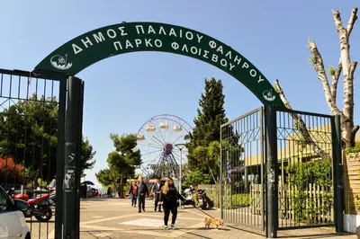 a gate at a park with a ferris wheel at Athens Sea view 2 floor apartment next to Marina in Athens