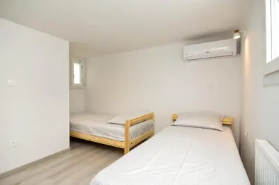 a bedroom with two beds and a window at Athens Sea view 2 floor apartment next to Marina in Athens