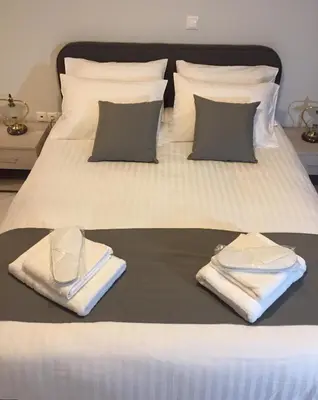 a bed with towels and pillows on it at V17 Syntagma Studio in Athens