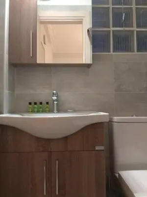 a bathroom with a white sink and a toilet at V17 Syntagma Studio in Athens