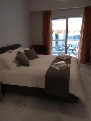 a bedroom with a large bed and a large window at V17 Syntagma Studio in Athens