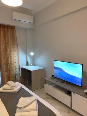 a living room with a flat screen tv on a table at V17 Syntagma Studio in Athens