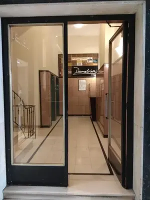 an open glass door in a building with a hallway at V17 Syntagma Studio in Athens