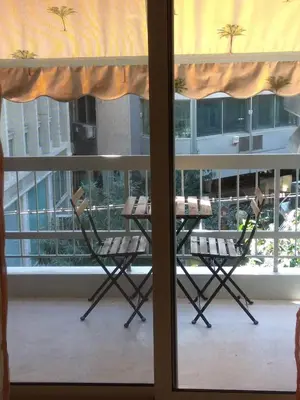 a table and chairs on a balcony with a window at V17 Syntagma Studio in Athens