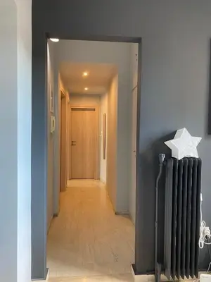 a hallway with a radiator and a door at ASIMINA apartment, Kerameikos Metro Station in Athens