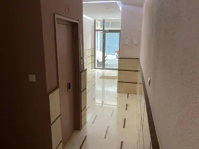 a hallway with a bathroom with a mirror and a door at ASIMINA apartment, Kerameikos Metro Station in Athens