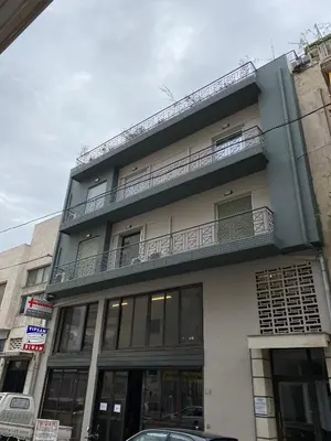 a tall building with a balcony on top of it at ASIMINA apartment, Kerameikos Metro Station in Athens