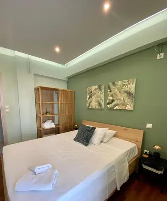 a bedroom with a bed with two towels on it at ASIMINA apartment, Kerameikos Metro Station in Athens