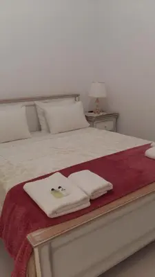 a bed with two towels on top of it at NN Spata Rooms & Suites near Athens airport in Spáta