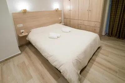 a bedroom with a white bed with two towels on it at Lovely central studio! in Athens