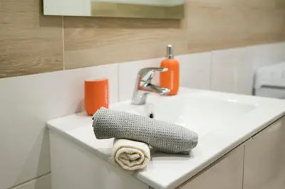 a bathroom sink with a towel and a faucet at Lovely central studio! in Athens