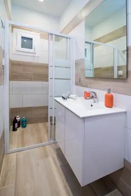 a bathroom with a sink and a mirror at Lovely central studio! in Athens