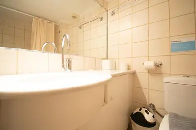 a bathroom with a sink and a toilet at Homey Penthouse in Kypseli in Athens
