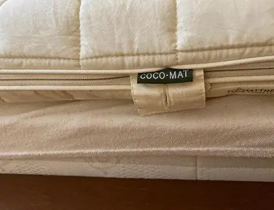 a stack of white mattresses with a sticker on top at Homey Penthouse in Kypseli in Athens