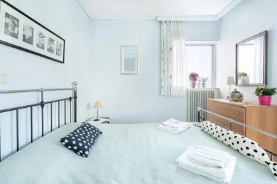 a bedroom with a bed with two pillows on it at Two Bedroom Apartment Near Alimos Marina ! in Athens