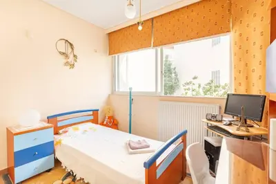 a bedroom with a bed and a desk with a computer at Two Bedroom Apartment Near Alimos Marina ! in Athens