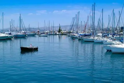a group of boats in a marina with a small boat at Two Bedroom Apartment Near Alimos Marina ! in Athens