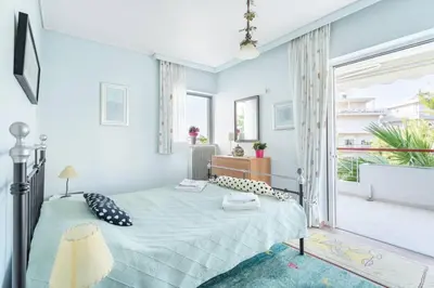 a bedroom with a bed and a large window at Two Bedroom Apartment Near Alimos Marina ! in Athens