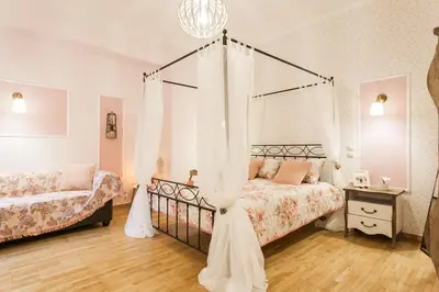 a bedroom with two beds and a canopy bed at Syntagma 3 Bedroom Sweet Simple And Practical Apartment in Athens