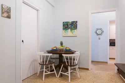 a dining room with a table and two chairs at Syntagma 3 Bedroom Sweet Simple And Practical Apartment in Athens