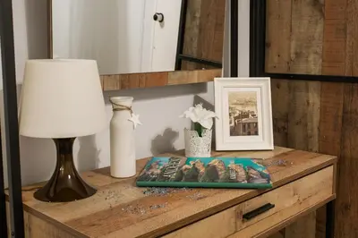a table with a lamp and a book on it at Syntagma 3 Bedroom Sweet Simple And Practical Apartment in Athens