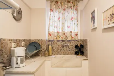 a kitchen with a sink and a window at Syntagma 3 Bedroom Sweet Simple And Practical Apartment in Athens
