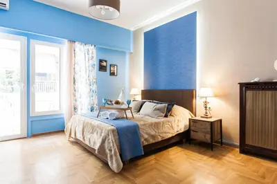 a bedroom with a bed and a blue wall at Cozy, Central, Safe apartment close to Acropolis in Athens