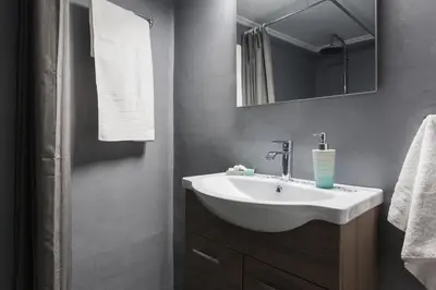 a bathroom with a white sink and a mirror at Cozy, Central, Safe apartment close to Acropolis in Athens