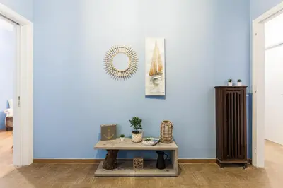 a room with a table and a blue wall at Cozy, Central, Safe apartment close to Acropolis in Athens