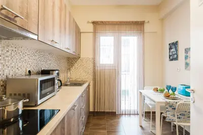 a kitchen with a microwave and a table at Museum of Modern Apartment next to Suggrou Fix metro- big, safe, simple and central in Athens