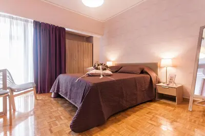 a bedroom with a bed in a room at Museum of Modern Apartment next to Suggrou Fix metro- big, safe, simple and central in Athens