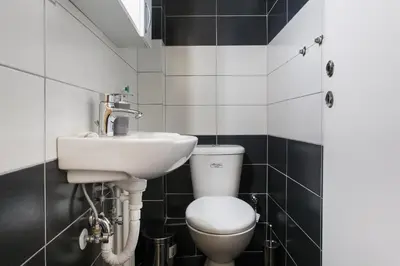 a bathroom with a toilet and a sink at Museum of Modern Apartment next to Suggrou Fix metro- big, safe, simple and central in Athens