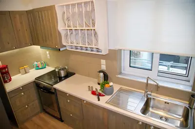 a small kitchen with a sink and a counter top at Aroura Homes Garden House 2BR 2BA Free Parking in Athens